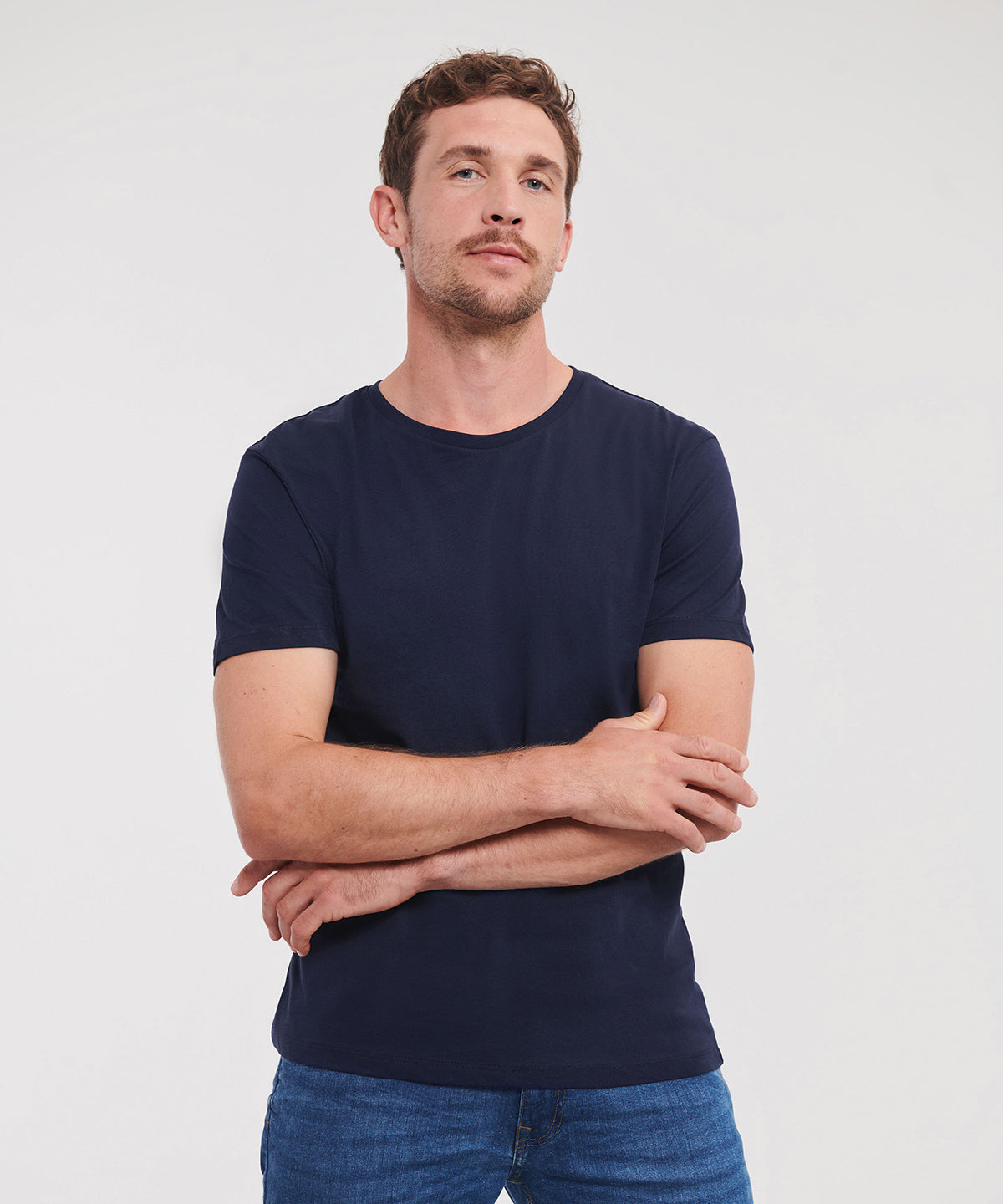 Front on image of Model wearing Russell Organic Tee with arms folded