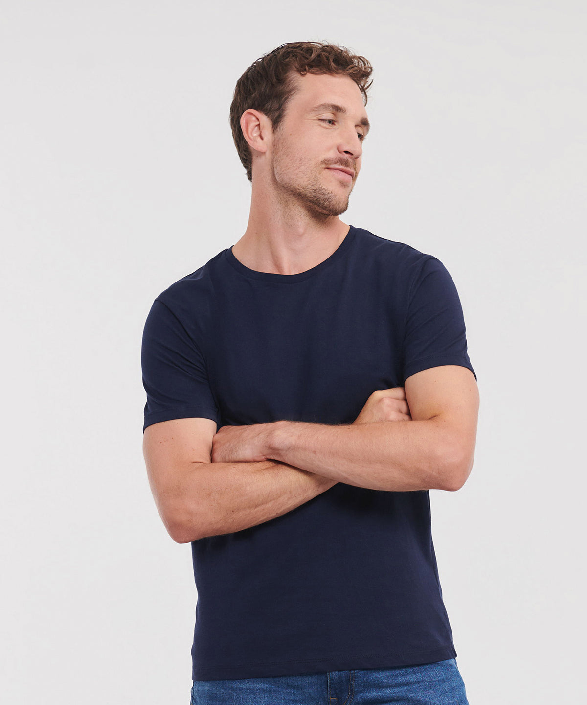 Front on image of Model wearing Russell Organic Tee with arms crossed
